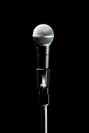 Black classic microphone on black dark background. Music and concert concept.の写真素材