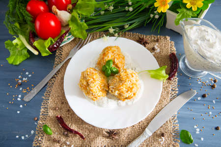 Meatballs with chicken and rice in sour cream sauce. Wooden background.の写真素材