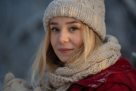Beautiful girl in a frosty winter forest on a sunny day