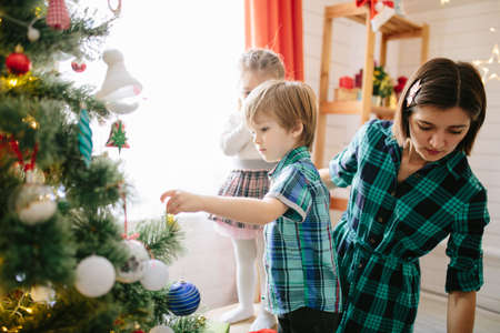 Happy family celebrating christmas in cozy attic roomの写真素材