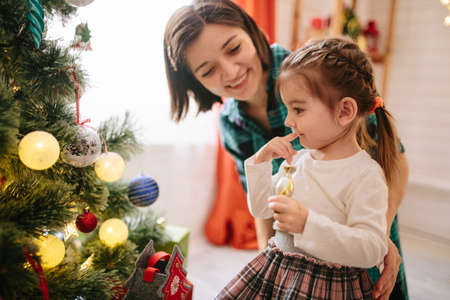 Happy family celebrating christmas in cozy attic roomの写真素材