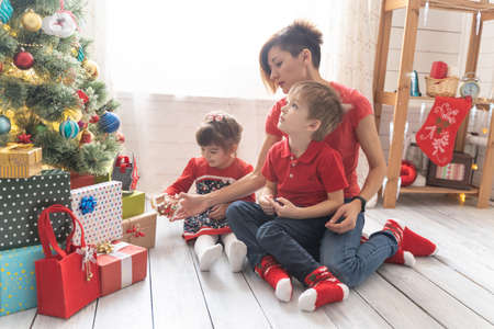 Family Opening Christmas Presents At Home Togetherの写真素材