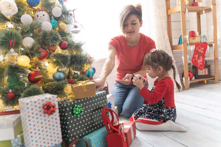 Family Opening Christmas Presents At Home Togetherの写真素材