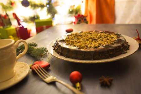 Cottages and gingerbread cookies on the Christmas table Gluten free christmas nut cake on a gray table with christmas decorationsの写真素材