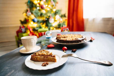 Cottages and gingerbread cookies on the Christmas table Gluten free christmas nut cake on a gray table with christmas decorationsの写真素材