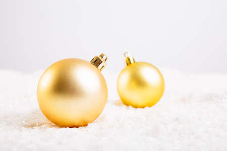 Christmas ball on snow over white backgroundの写真素材