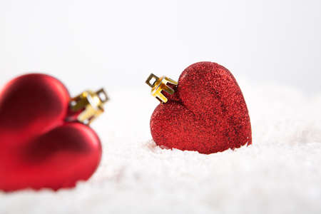 Christmas hearts on snow over white backgroundの写真素材