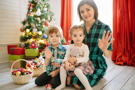 Happy family celebrating christmas in cozy attic roomの写真素材