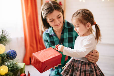 Happy family celebrating christmas in cozy attic roomの写真素材