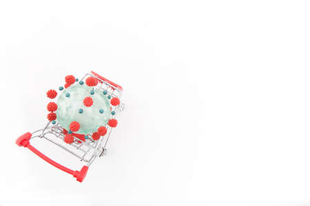 Coronavirus model in a shopping cart on a white backgroundの写真素材