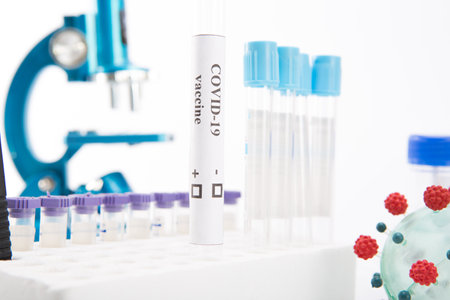 Test tube with a vaccine against coronovirus infection COVID-19 on a white backgroundの写真素材