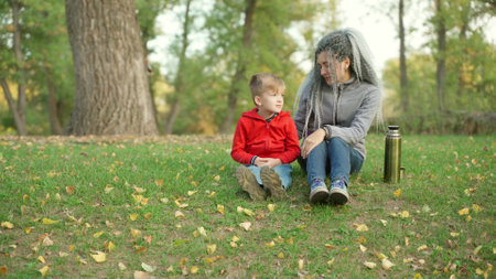Mom with her son in the park in autumnの写真素材