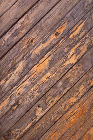 Abstract background old cracked diagonal wooden bars wall with knotsの写真素材
