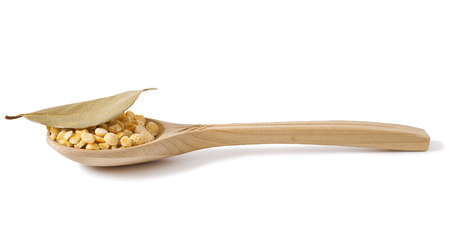 dry peas over wooden spoon isolated on whiteの写真素材