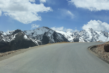 snow mountain with road in chinaの写真素材