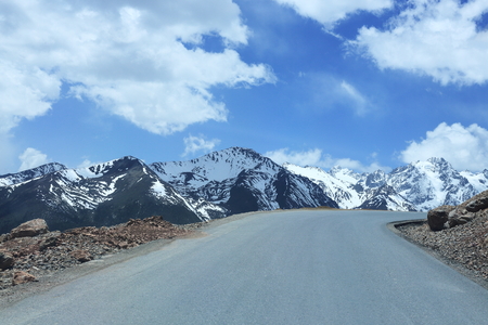 snow mountain with road in chinaの写真素材