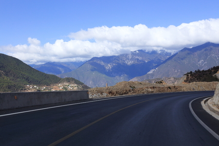 snow mountain with road in chinaの写真素材