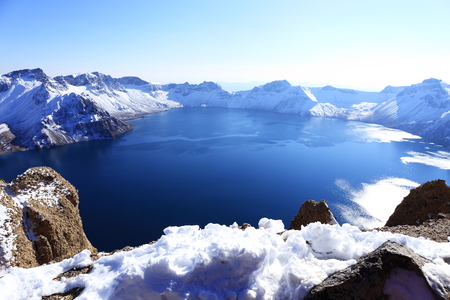 crater lake with snow in winterの写真素材