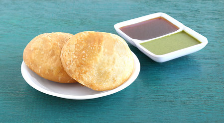 Kachori, a vegetarian food, native to the state of Rajasthan, India, and green and tamarind...
