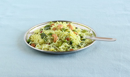Rice noodles, a healthy and spicy south Indian vegetarian steam-cooked food, on a steel plate with...