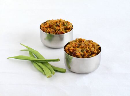 Cluster beans curry, also known as gawar ki sabzi, is a healthy, Indian, and vegetarian side dish for items like chapathi and roti, in steel bowls.の写真素材