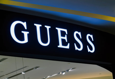 Guess logo on a store front. Guess is an American upscale clothing line brand popular with its brand...
