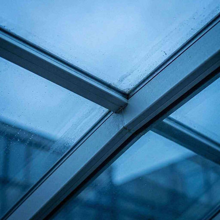 glass window with raindrops in a modern office building, close up
