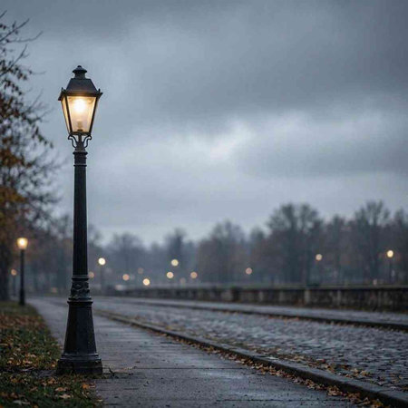 Lantern on the railway track in the foggy autumn evening