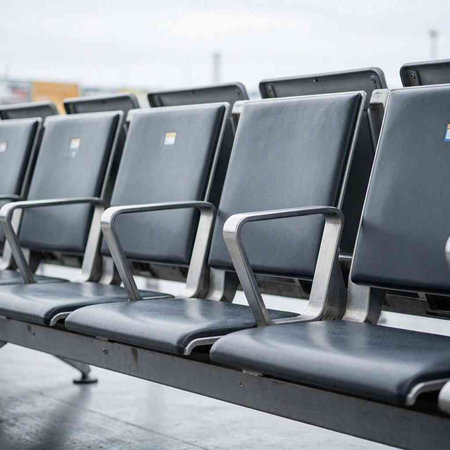 Empty seats in a row on the airport terminal. Selective focus.