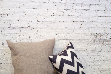 warm white brick wall with pillow interior roomの写真素材