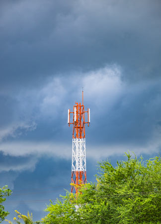 Antenna large red white color and cloud stormの写真素材
