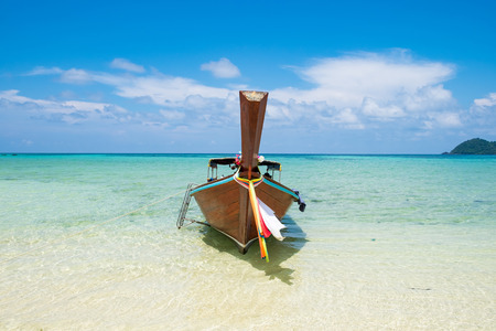 Long tail wooden boat anchor with csytal sea white sand at lipe island,andaman,thailandの写真素材