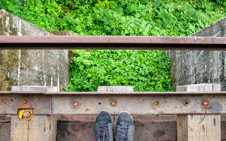 Black sneaker on wooden old railroad of history world war IIの写真素材