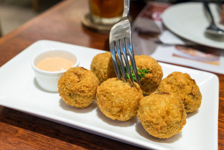 Eating clams cheese ball bake cooked on white plate