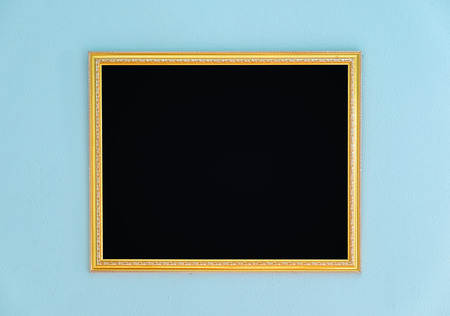 Gold frame tracery blank decor on aqua wallの写真素材