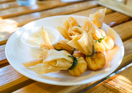 Thai money bag,toong thong,fried shrimp dumplings served with sweet plum sauceの写真素材