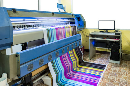 Large inkjet printer working multicolor cmyk on vinyl banner with computer control in printing plant