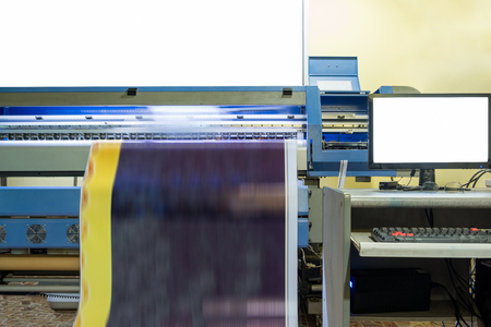 Large inkjet printer working on vinyl banner with computer controlの写真素材