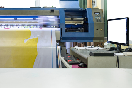 Large inkjet printer working on vinyl banner with computer controlの写真素材