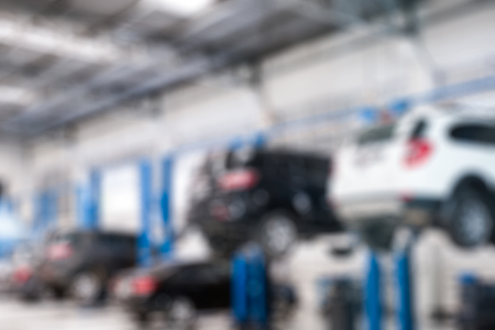 Blurred scene cars lifting repair check and fix a problem in garageの写真素材