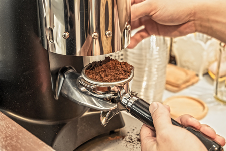 Hands holding coffee grinder powder,warm toneの写真素材