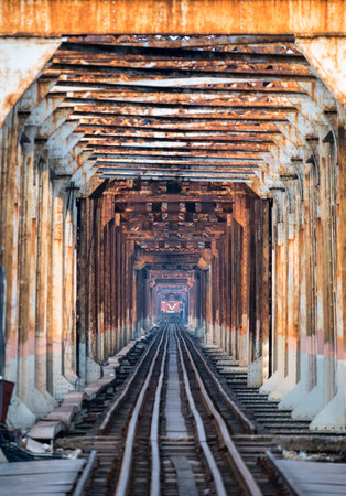 Train running on ancient railway on Long Bien bridge in Hanoi, Vietnam