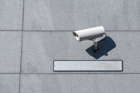 White camera security (CCTV) setting with blank plate on wall