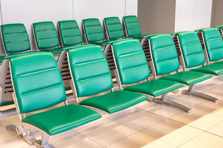 Rows of modern green chairs in waiting room loungeの写真素材