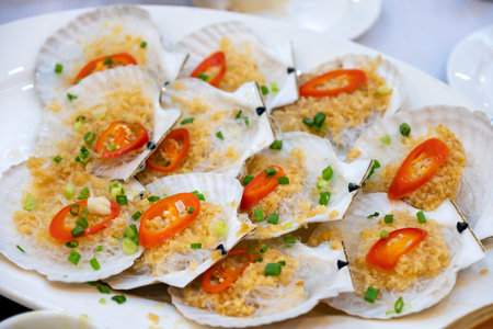 Grilled scallops with butter and vegetable in shell arrangement