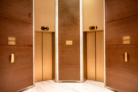 Closed elevator doors. Contemporary interior wooden curvedの写真素材