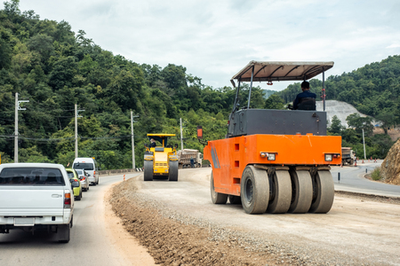 Road construction repairing with compactors on highwayの写真素材