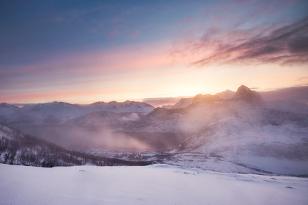 Colorful sunrise on snowy mountain rangeの写真素材