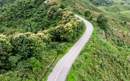 Asphalt curved highway on tropical mountainの写真素材