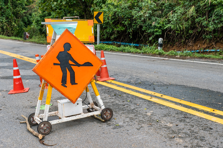 Traffic signs improve repairing on highway with landslide collapsed roadの写真素材